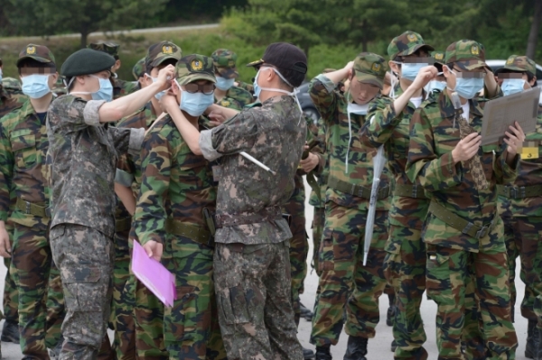 지난 2015년 6월 메르스 유행 당시 경기도 의정부시 호원예비군훈련장에서 메르스 예방을 위해 교관들이 훈련에 앞서 교육생에게 마스크 착용을 도와주고 있다. [사진=사진공동취재단]
